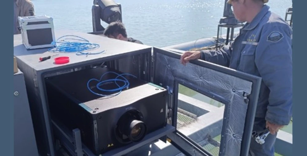 Engineers from Beijing Zhongqing Display Technology installing the Crimson WU32 projectors in weatherproof enclosures 