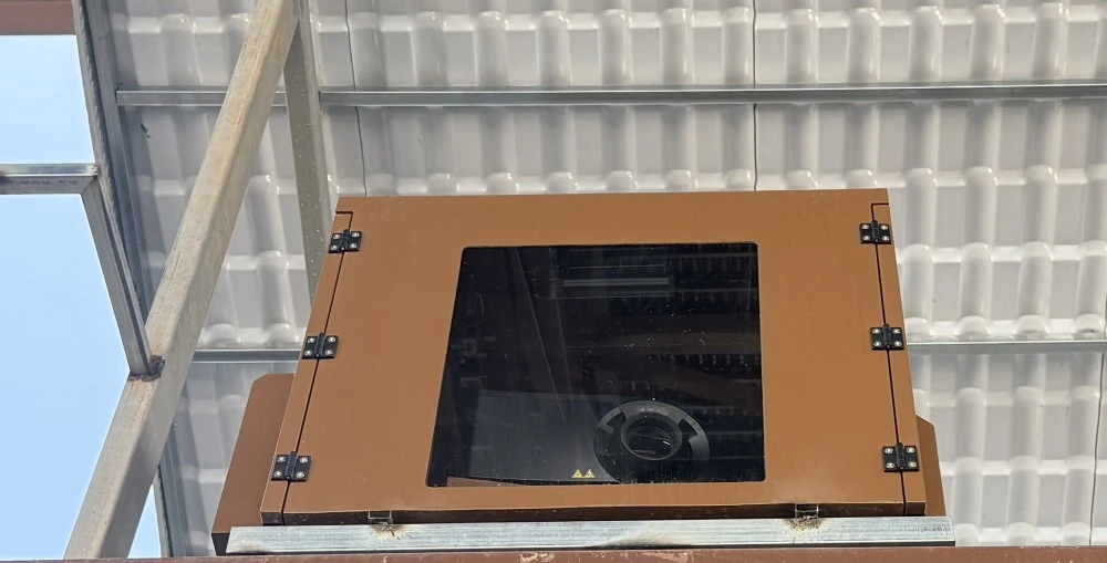 Christie DWU19-HS projector is shown housed within a weatherproof enclosure 