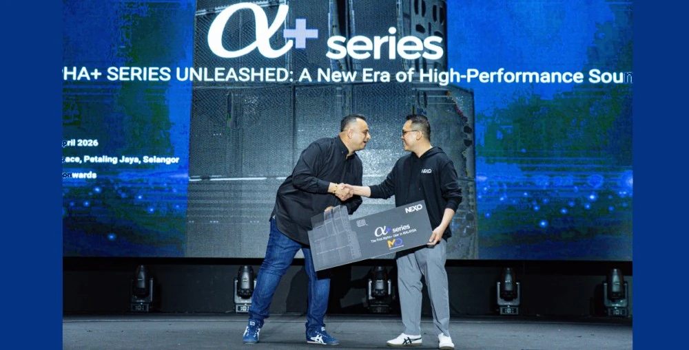 Andrew Lee, the Director of Audio Solutions, presenting the ceremonial mock key to Jack Gill, Managing Director of MD Events Asia Sdn Bhd, marking MD Events as the first official owners of the NEXO Alpha+ Series in Malaysia