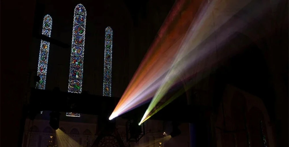 Truss-mounted projectors displayed Earth-to-cosmos visuals across the church’s soaring arches, vaulted ceilings and stained-glass windows