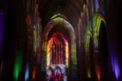 Truss-mounted projectors displayed Earth-to-cosmos visuals across the church’s soaring arches, vaulted ceilings and stained-glass windows