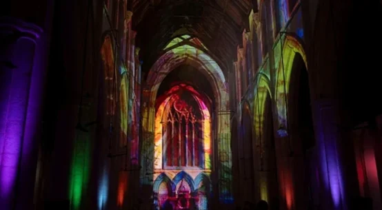 Truss-mounted projectors displayed Earth-to-cosmos visuals across the church’s soaring arches, vaulted ceilings and stained-glass windows